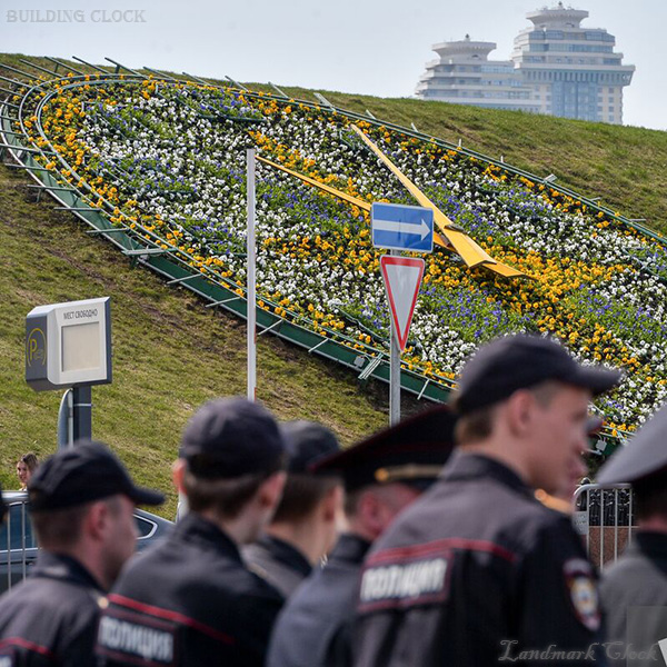 Municipal landmark flower clock integrated into a ceremonial park landscape Municipal landmark flower clock integrated into a ceremonial park landscape