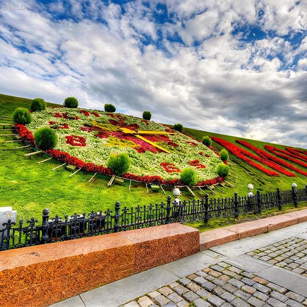 Oval floral clock planting face with bold color fields for public-space placemaking Oval floral clock planting face with bold color fields for public-space placemaking